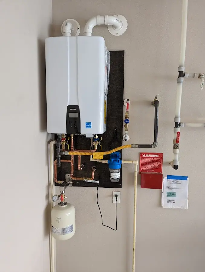 Professional plumber installing copper piping in a Bothell home